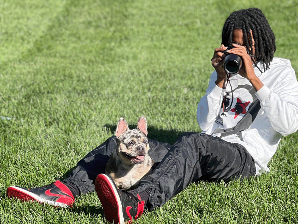 owner posing with frenchie coco
